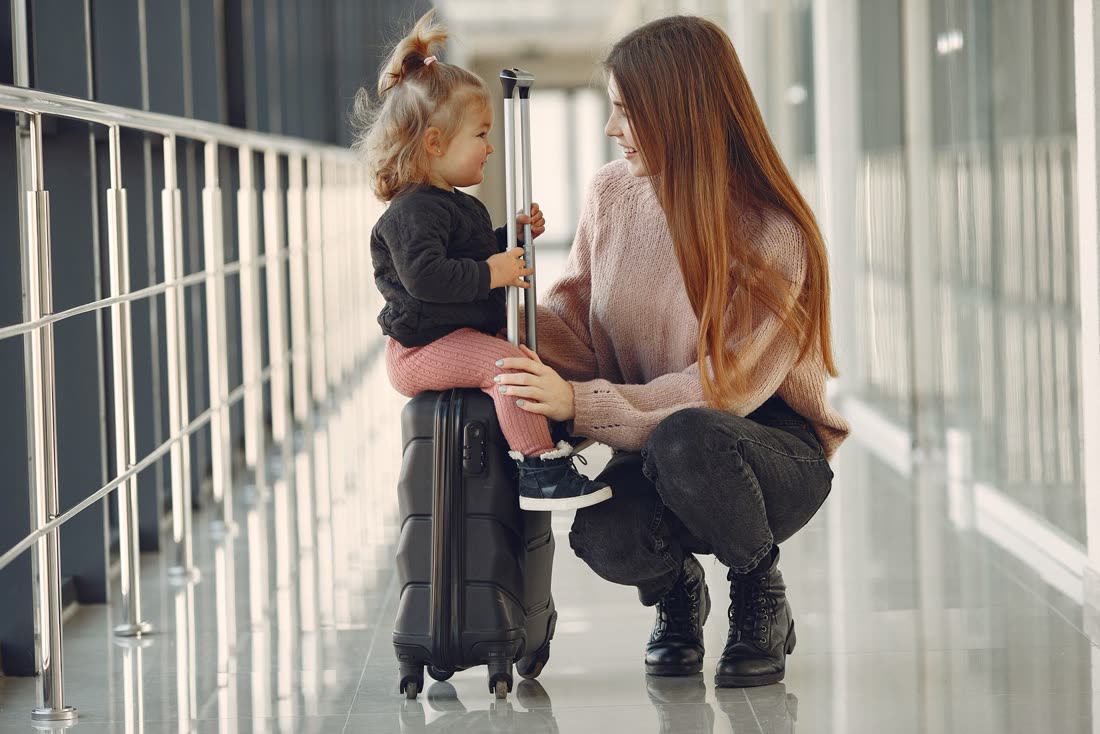 Mãe e filha com mala no aeroporto